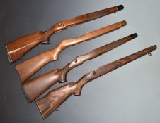 Four bolt-action wooden rifle stocks, some with chequered semi-pistol grips, sling mounts and inlay.