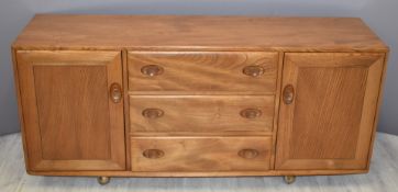 Retro / mid century Ercol light elm Windsor sideboard comprising of three central drawers with