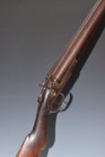L C Smith 12 bore side by side hammer action shotgun with named locks, chequered semi-pistol grip
