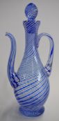 Glass ewer with blue and white cotton twist decoration, signed to base, 28cm tall.