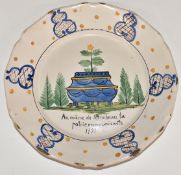 An 18th/19th century French Delft plate decorated with a jardinière, diameter 23cm