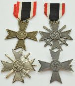 Four German WW2 Third Reich Nazi War Merit Cross medals, two with crossed swords, one stamped 3 to