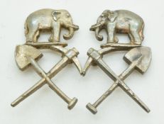Two small collar badges, elephant over crossed pick and shovel, stamped Sterling