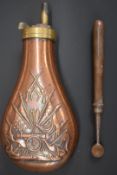 Copper and brass powder flask with embossed decoration of a cannon and flags together with a