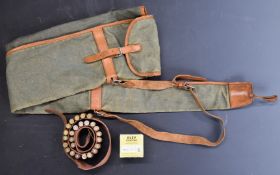 Fifty .410 shotgun cartridges together with a .410 canvas and leather cartridge belt and similar gun