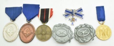 Seven German WW2 Third Riech Nazi badges including Merit Medal and Reich Labour Service 12 Year