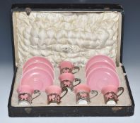 Set of six Aynsley bone china coffee cans and saucers, the cans with hallmarked silver holders, in