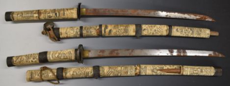 Two Japanese short swords with ornately carved bone handles and scabbards, overall length 85cm