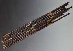 Nine vintage wooden and brass multi-piece cleaning rods.