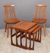 A pair of Ercol style beech stick back chairs and a retro set of three nest of three teak tables,