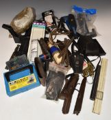 A collection of gun parts and accessories including air rifle sound moderators, springs, bullet