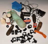 A collection of gun and shooting accessories including scope mounts, cleaning kit, butt plates,
