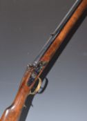 Mendi flintlock Kentucky style rifle with brass scrolling spurred trigger guard, butt plate and