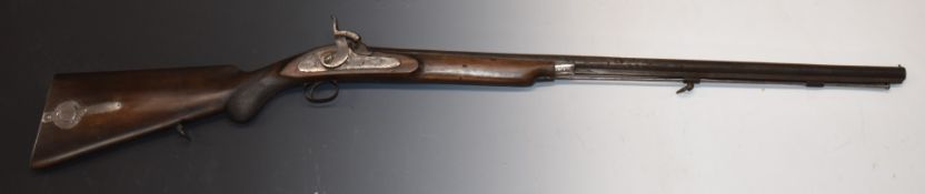 Unnamed 20 bore percussion hammer action gun with chequered semi-pistol grip, storage compartment to