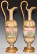 A pair of c1900 Royal Doulton pedestal ewers hand decorated with flowers, H 35cm