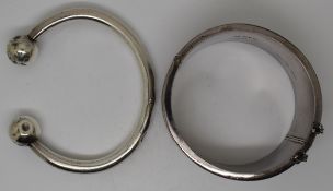 Silver bangle with chased floral decoration and another silver bangle with featured hallmarks
