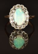 A 9ct gold ring set with an opal and white sapphires, size K, 2.3g