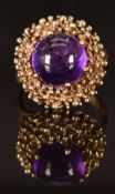 A 9ct gold ring set with an amethyst cabochon, size K/L, 5g