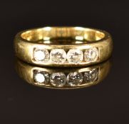 An 18ct gold ring set with four round cut diamonds, size M, 4.9g