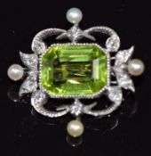 A c1910 gold brooch set with an emerald cut peridot, diamonds and pearls, 5g