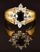 An 18ct gold ring set with a round cut sapphire and diamonds, size P, 9g