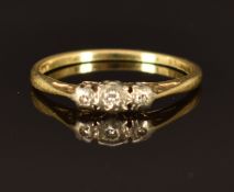 An 18ct gold ring set with three diamonds, size L/M, 1.8g