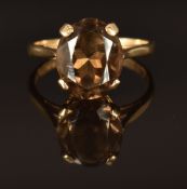 A 9ct gold ring set with an oval cut smoky quartz, size Q, 3.2g