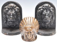 Pair of cast iron bookends / doorstops with lion mask decoration and a brass Guy car or lorry