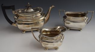 George V Walker & Hall hallmarked silver three piece teaset, raised on four ball feet, Birmingham
