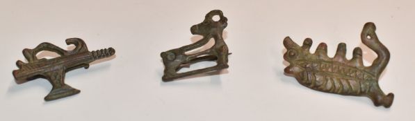 Three Roman bronze brooches including axe and stag