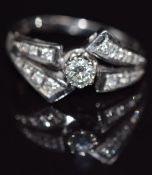 A white gold ring set with diamonds, the centre stone approximately 0.4ct, marked 590, size U, 4.9g