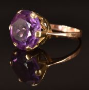 A 9ct gold ring set with a large synthetic colour change purple sapphire, size O, 5.3g