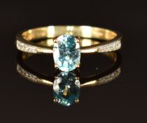 A 9ct gold ring with an oval sapphire and white sapphires, size P, 2g