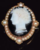 A 19thC yellow metal brooch set with a hardstone cameo set with a split pearl surround, engraved