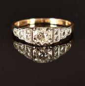 An 18ct gold ring set with a diamond in a platinum setting, size J, 2.4g