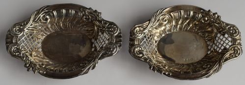 Victorian pair of hallmarked silver bon bon dishes with pierced and embossed decoration, Chester