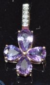 A 14k rose gold pendant set with purple sapphires and diamonds, 1.6g