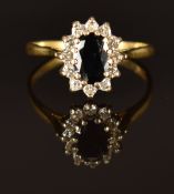 An 18ct gold ring set with a sapphire and diamonds, size K/L, 2.7g