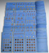 Seven Whitman coin folders containing various UK coinage including silver content, threepences etc