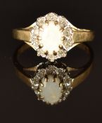 A 9ct gold ring set with an opal surrounded by diamonds, size K, 1.5g