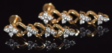 A pair of 18ct gold earrings set with diamonds with heart decoration, 7g