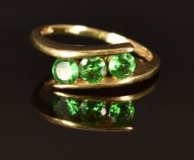 A 9k gold ring set with three round cut tsavorite garnets, size L/M, 2.2g
