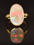 An 18ct gold ring set with an opal, size L, 4.6g