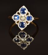 An 18ct gold ring set with a diamond of approximately 0.25ct and cushion cut sapphires, size K, 2.4g