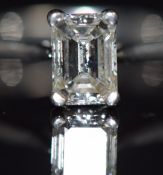 A platinum ring set with an emerald cut diamond of approximately 1.02ct, with original receipt
