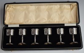 George V cased set of six hallmarked silver shot measures or tots, Birmingham 1928, maker Adie