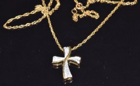 A 9ct gold cross pendant set with diamonds on a 9ct gold chain, 2.3g