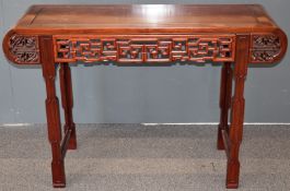 Carved oriental hardwood altar table with carved decoration, W127 x D43 x H83cm