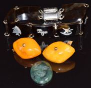 A pair of Baltic amber cufflinks on yellow metal mounts, a tortoiseshell bracelet and a carved agate