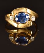 An 18ct gold ring set with an oval cut sapphire and diamonds, size J, 4.3g